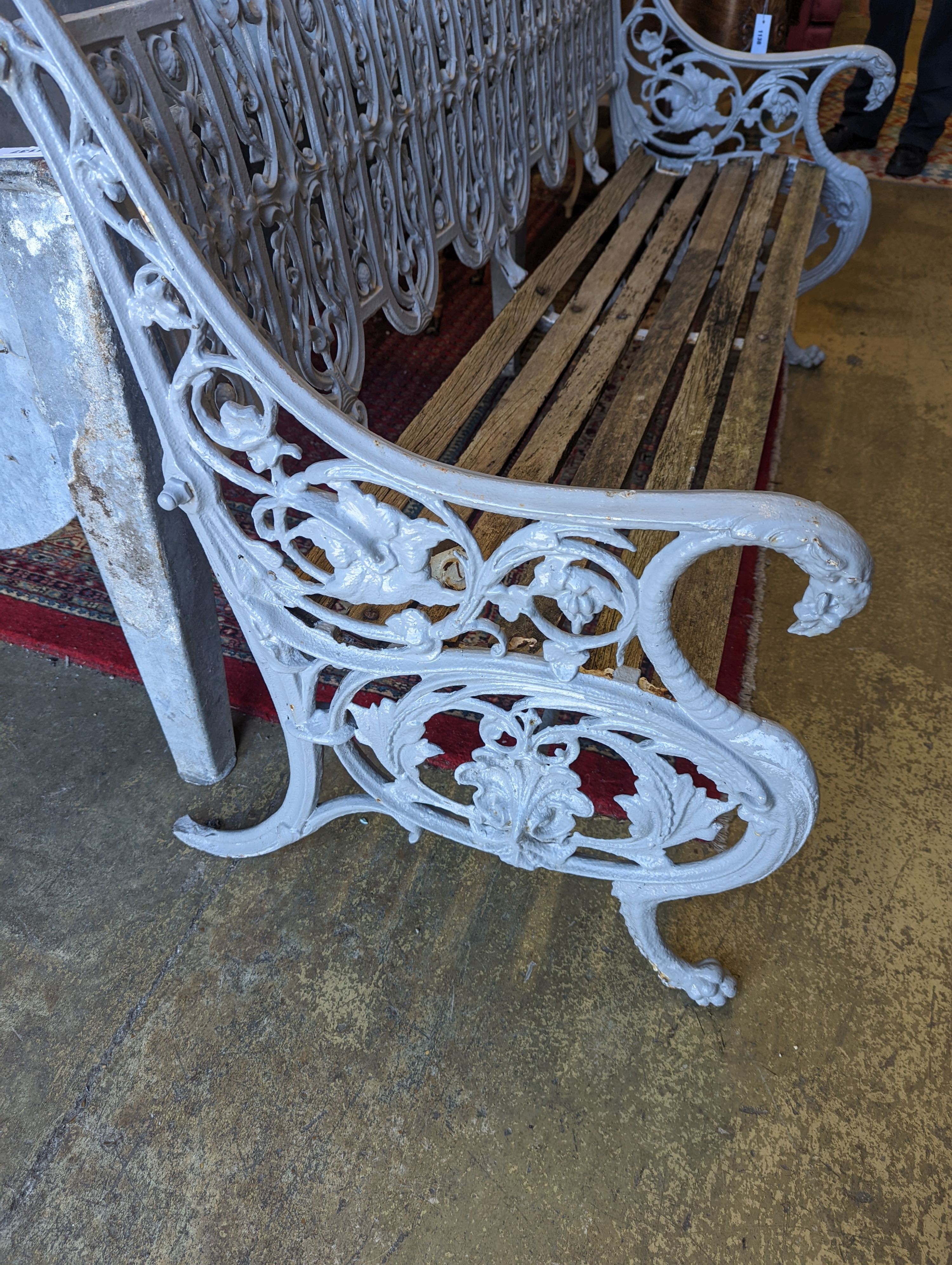 A Victorian Coalbrookdale cast-iron garden bench, length 156cm, depth 68cm, height 94cm (re-painted and seat in need of repair)